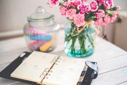 Picture of Daily Planner book on a table with flowers