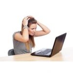 Image of a frustrated woman using a computer